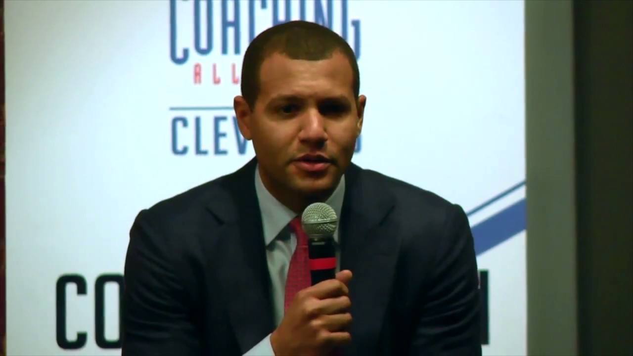 Koby Altman speaks into the mic.