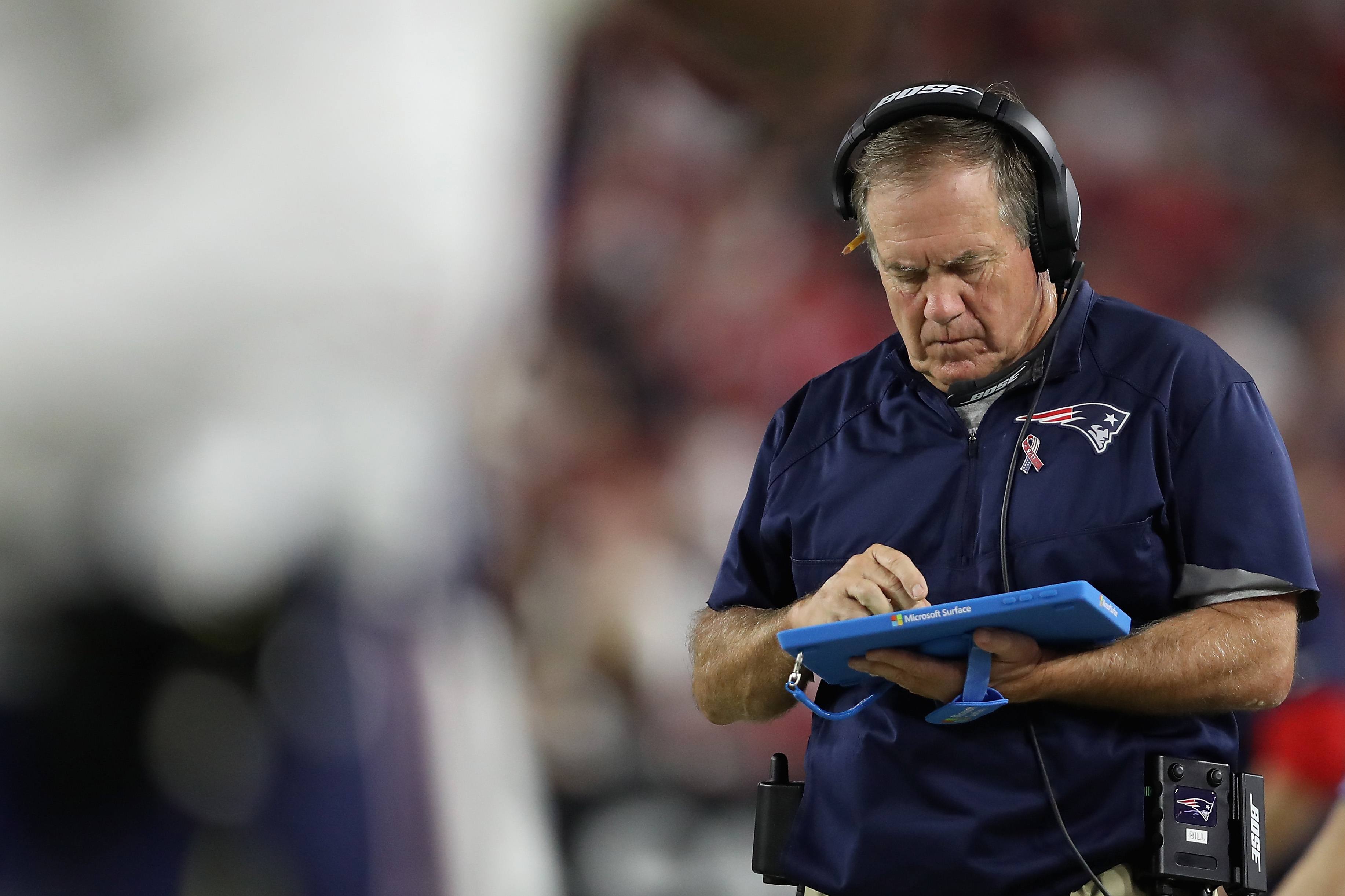 GLENDALE, AZ - SEPTEMBER 11: Head coach Bill Belichick of the New England Patriots works on a microsoft surface tablet as he walks the sidelines during the NFL game against the Arizona Cardinals at the University of Phoenix Stadium on September 11, 2016 in Glendale, Arizona. The Patriots defeated the Cardinals 23-21. (Photo by Christian Petersen/Getty Images)