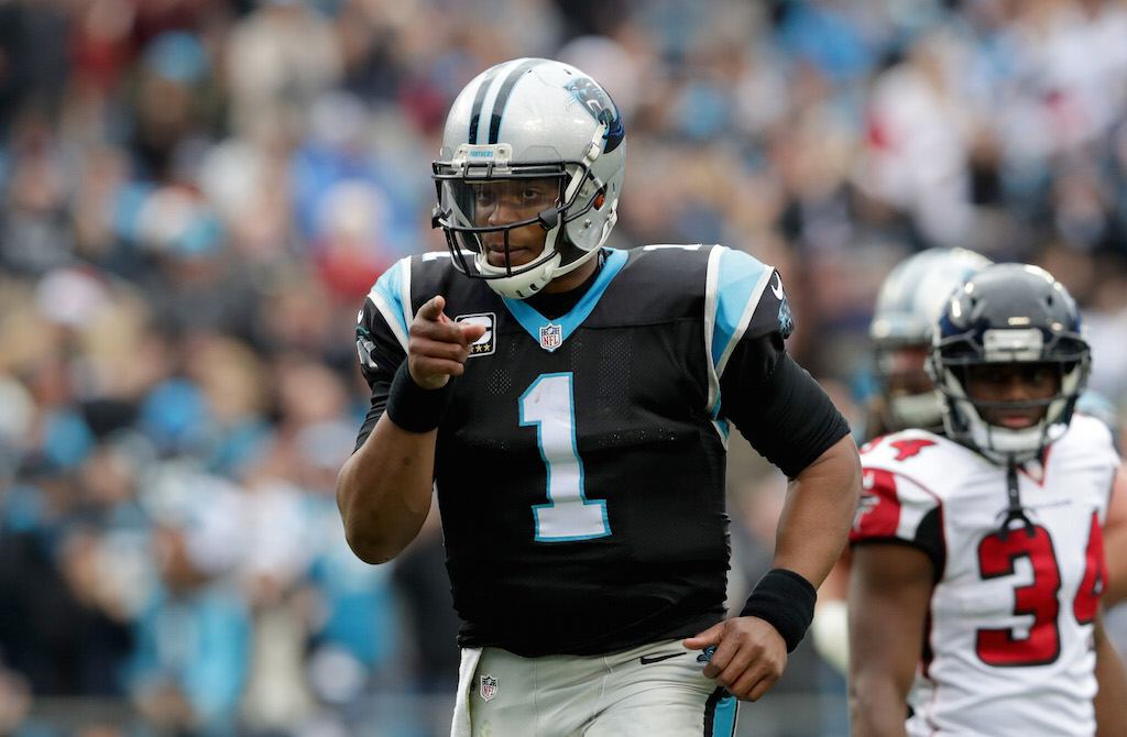 Cam Newton points to a teammate following a touchdown. Cam Newton reacts to a touchdown throw.