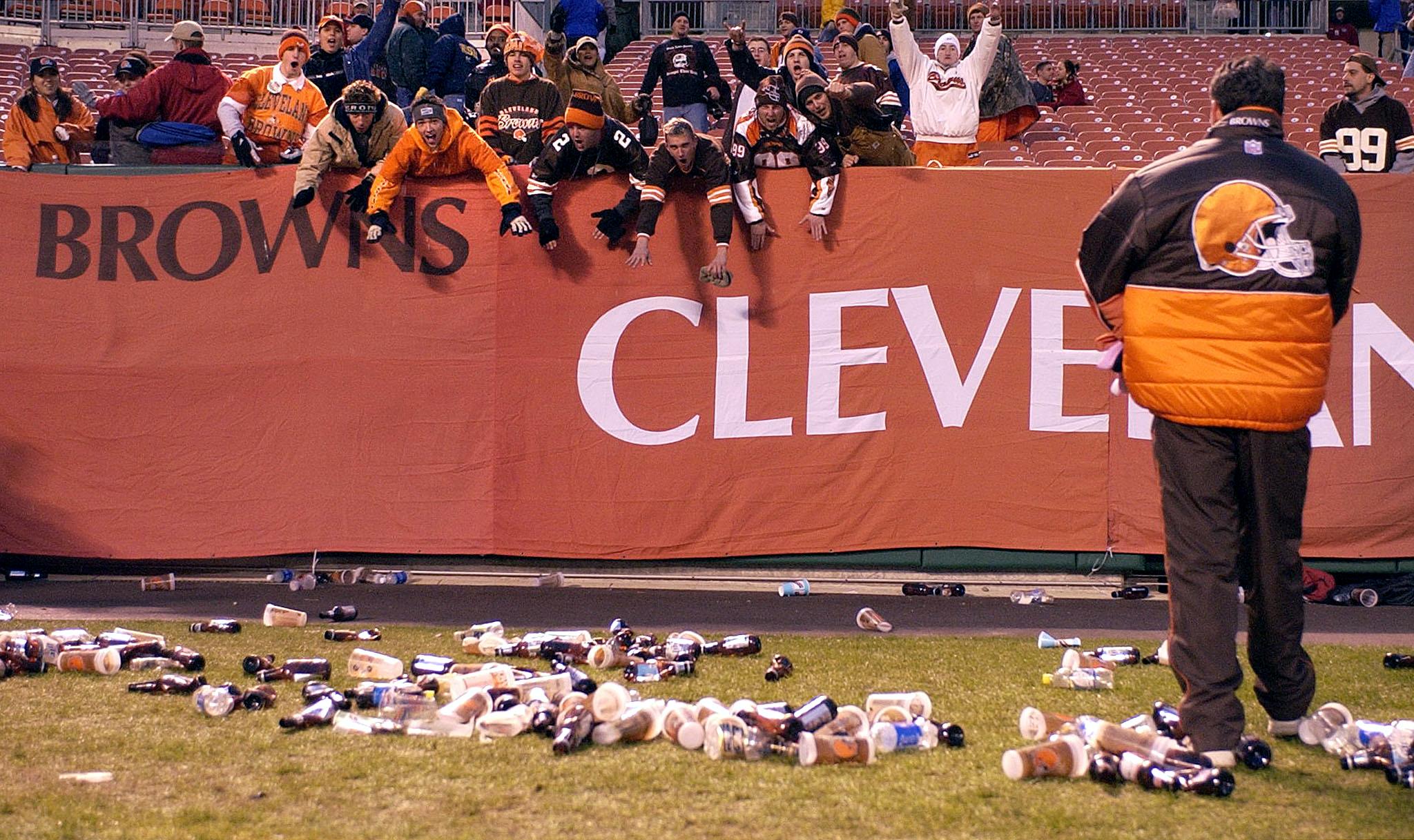 Bottles and debris litter the field at Cleveland Browns Stadium.