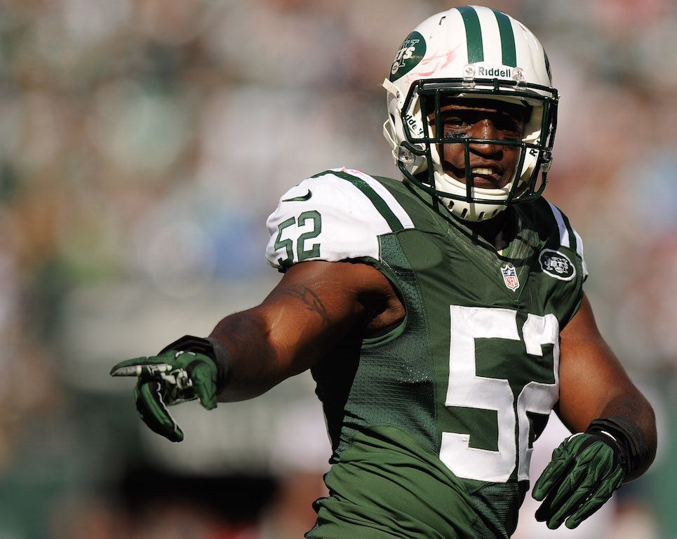David Harris signals the team. Linebacker David Harris reacts to a play.