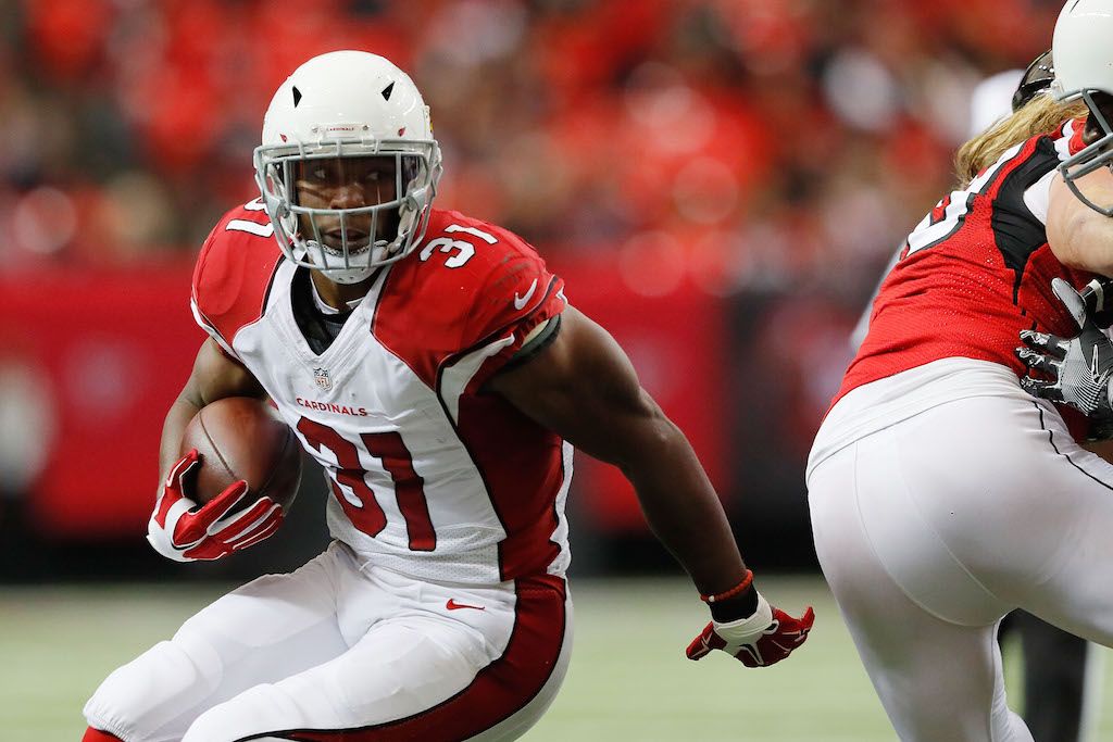David Johnson looks for an opening. David Johnson rushes the ball.