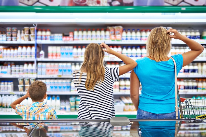 Family chooses dairy products in market.
