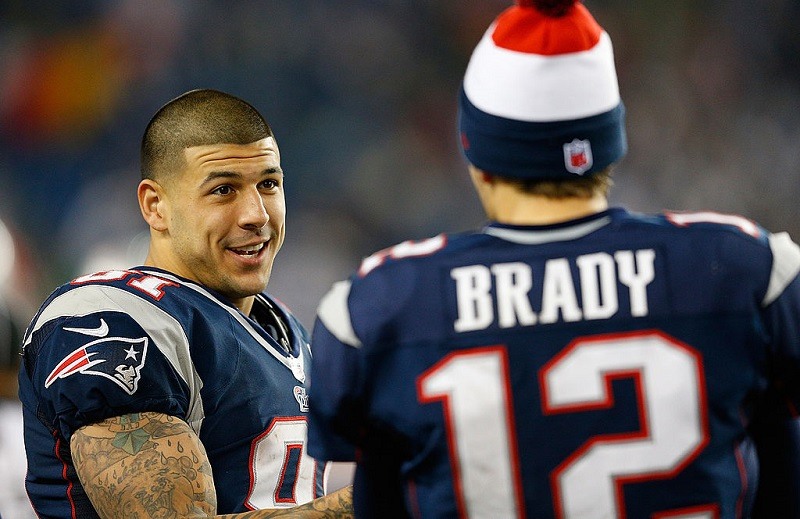 FOXBORO, MA - DECEMBER 10: Tom Brady #12 of the New England Patriots chats with Aaron Hernandez #81 against the Houston Texans at Gillette Stadium on December 10, 2012 in Foxboro, Massachusetts.