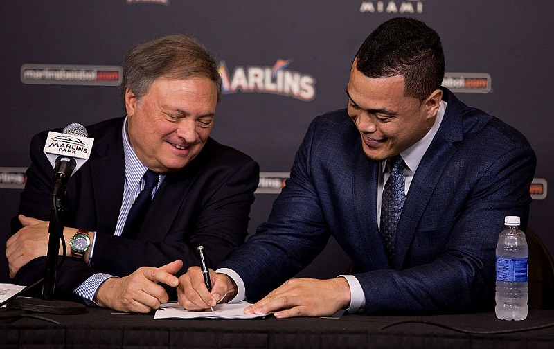 Giancarlo Stanton signs a contract with the Miami Marlins as owner Jeffrey Loria looks on during a press conference at Marlins Park on November 19, 2014 in Miami, Florida.