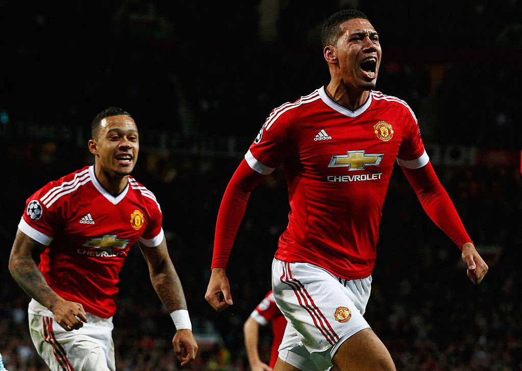 Chris Smalling of Manchester United celebrates with teammate Memphis Depay as he scores their second goal.