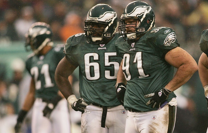 Jamaal Green #65 and Sam Rayburn #91 of the Philadelphia Eagles stand on the field.