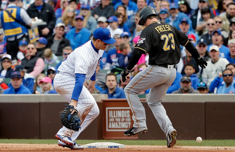 Cubs first baseman Anthony Rizzo makes an error while David Freese crosses the bag.