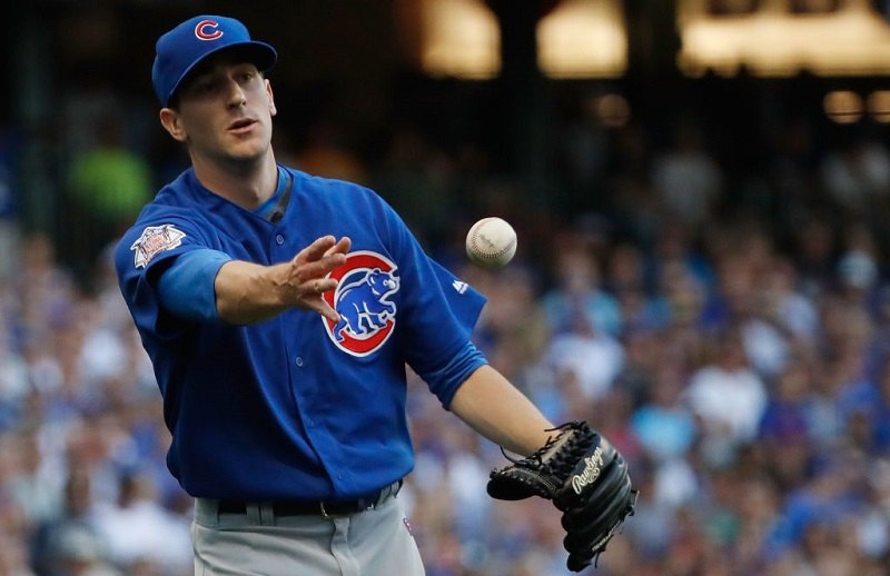 Kyle Hendricks tosses his teammate the ball during a game.