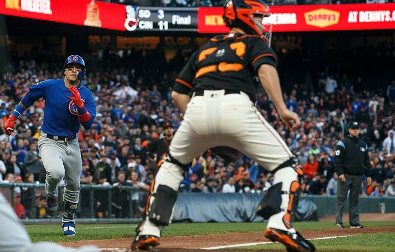 SAN FRANCISCO, CA - AUGUST 07: Javier Baez #9 of the Chicago Cubs rounds third base to score a run past Buster Posey #28 of the San Francisco Giants after hitting a two run inside the park home run during the second inning at AT&T Park on August 7, 2017 in San Francisco, California.
