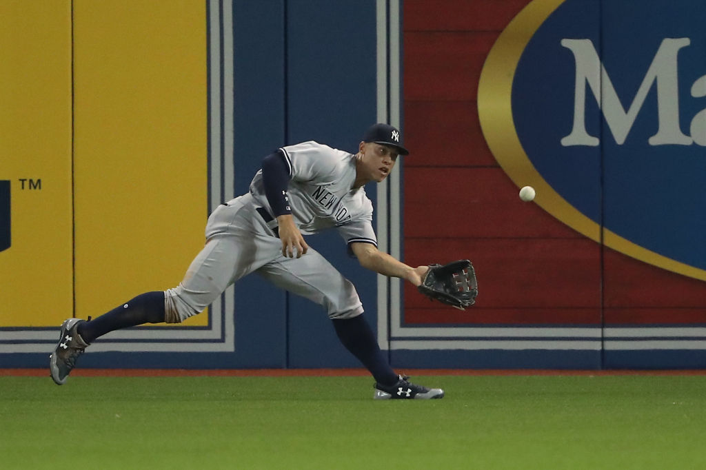 Aaron Judge #99 of the New York Yankees makes a running shoestring catch.