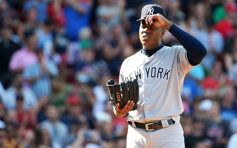 Aroldis Chapman squints during a sunny day at Fenway Park.