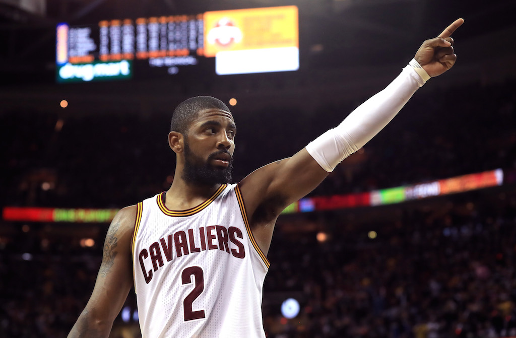 Kyrie Irving gestures to the crowd.