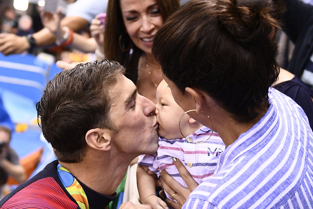 Michael Phelps kisses his son