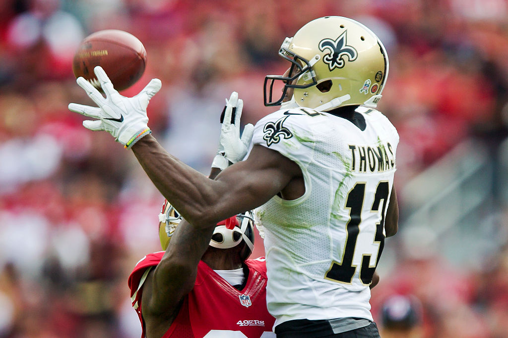 Wide receiver Michael Thomas of the New Orleans Saints tries to pull in a pass against the San Francisco 49ers.