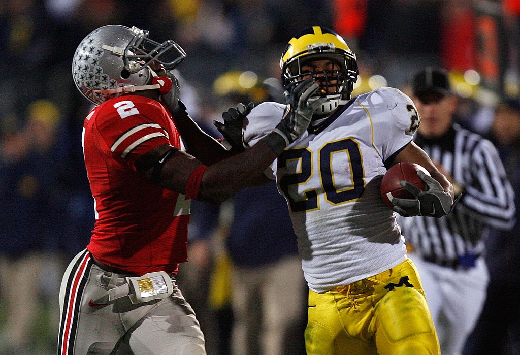 Mike Hart of the Michigan Wolverines stiff arms Malcolm Jenkins of the Ohio State Buckeyes.