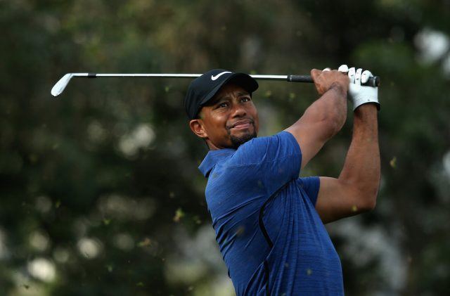 Tiger Woods follows his shot. Tiger Woods tees off.