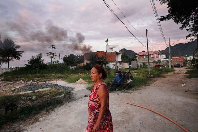 Resident Marize do Amor Divino, who said she was diagnosed with the Zika virus two weeks ago, walks in the mostly demolished Vila Autodromo favela community Rio de Janeiro, Brazil. Resident Marize do Amor Divino, who said she was diagnosed with the Zika virus two weeks ago, walks in the mostly demolished Vila Autodromo favela community Rio de Janeiro, Brazil.