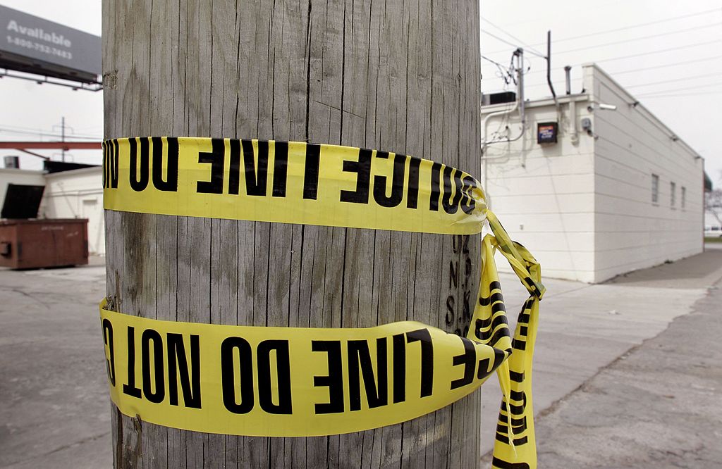 Crime scene tape wrapped around a telephone pole in Detroit. crime tape in Detroit