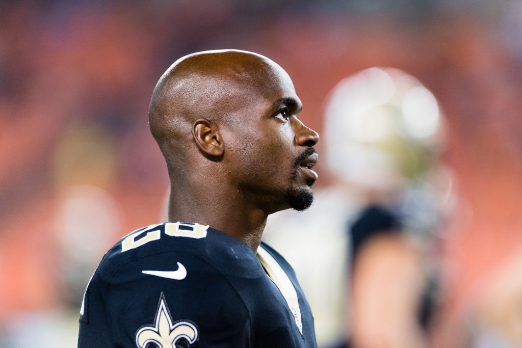 Adrian Peterson with his helmet off, looking off to the right of the frame