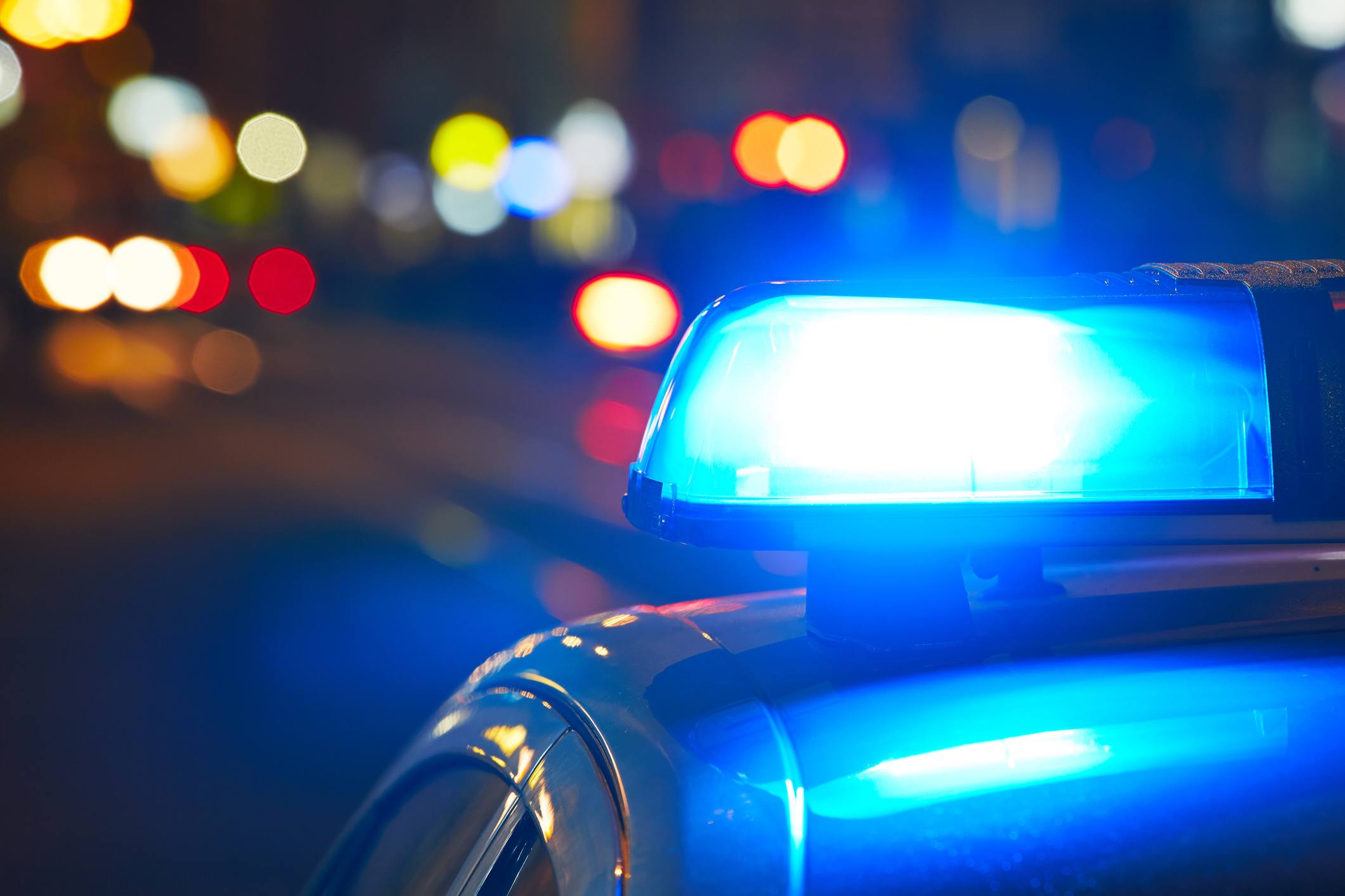 Blue police light on top of a police car at night Blue police light on top of a police car at night.