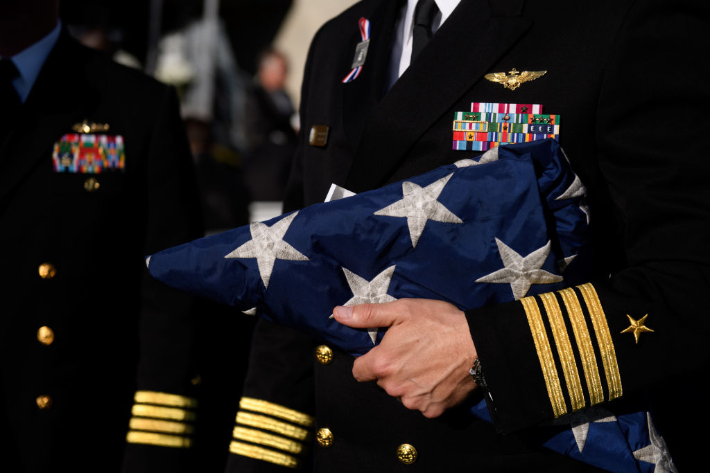 military member holding flag