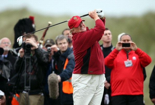 trump golfing in abderbeen as the press look on