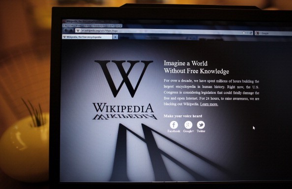 a laptop displaying the wikipedia mission statement a laptop displaying the wikipedia mission statement