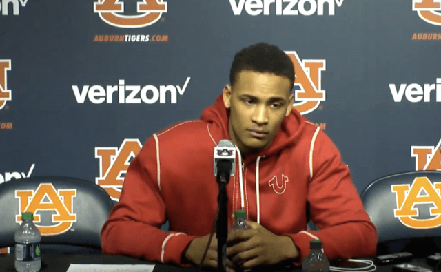 Bryce Brown sitting in front of a microphone. Bryce Brown sitting in front of a microphone.