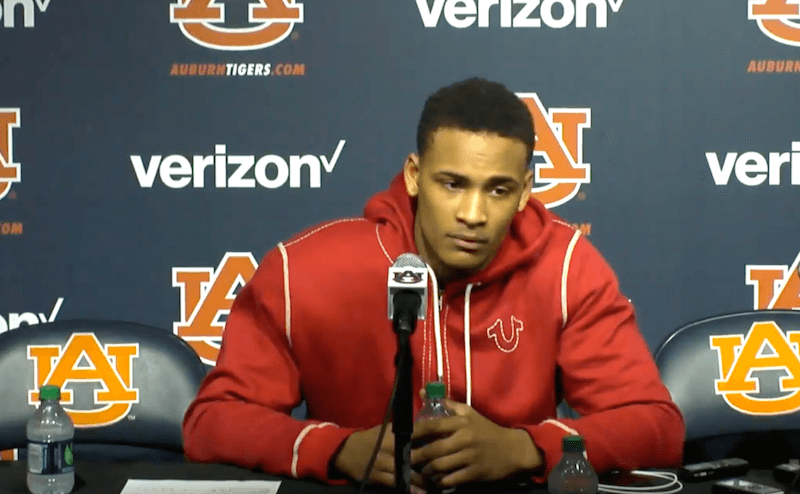 Bryce Brown sitting in front of a microphone. Bryce Brown sitting in front of a microphone.