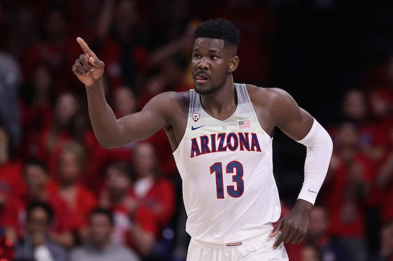 Deandre Ayton pointing ahead while standing on the basketball court. 