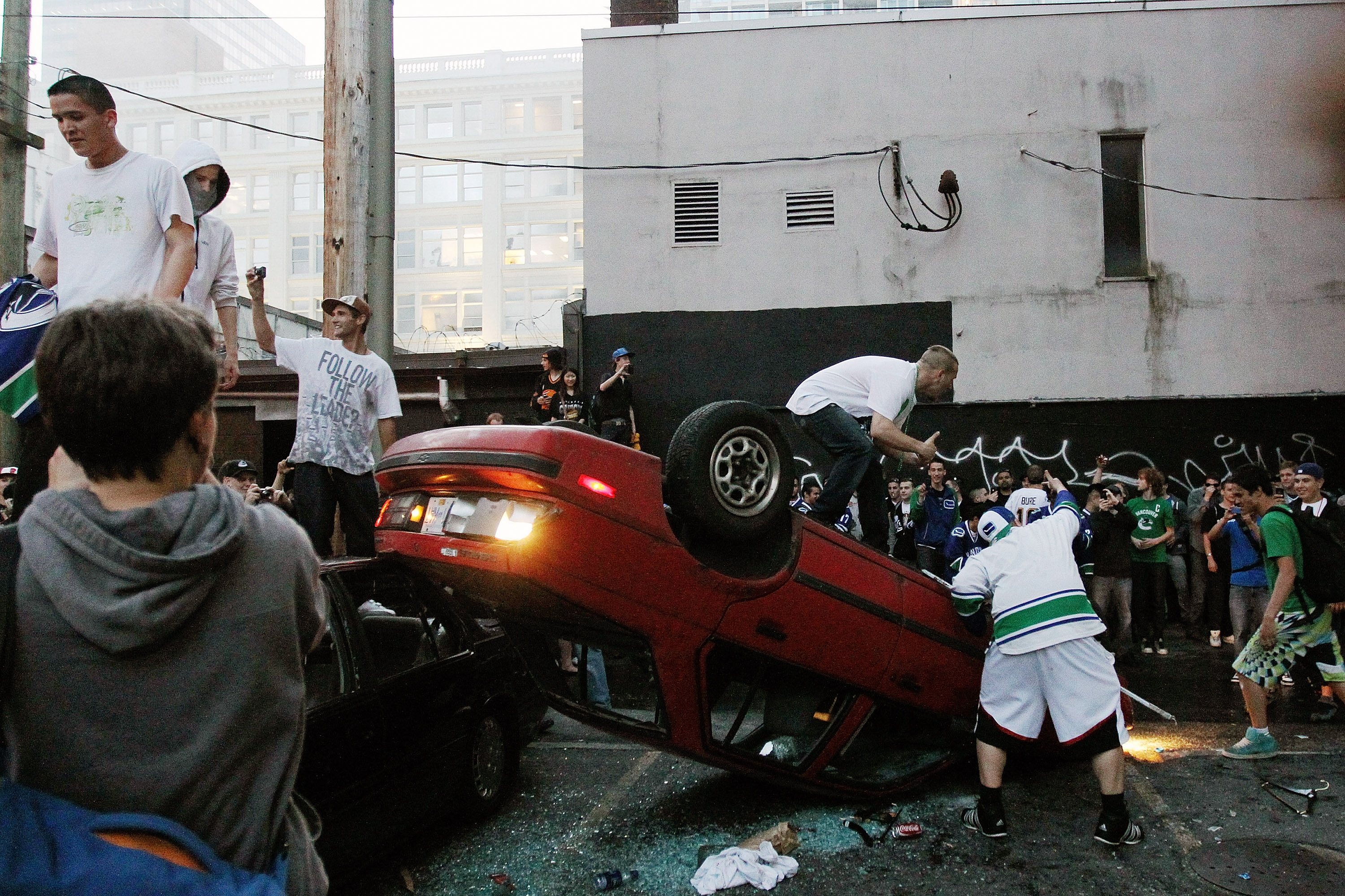 People flip a vehicle during Vancouver Stanley Cup celebrations People flip a vehicle during Vancouver Stanley Cup celebrations