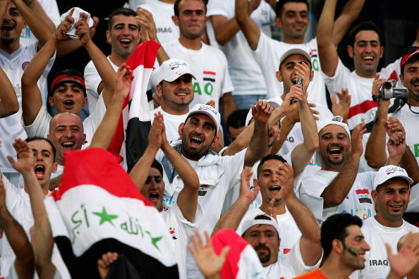 Iraqi soccer fans cheer their team before they compete in the men's football preliminary match between Iraq and Portugal during the Athens 2004 Summer Olympic Games at Pampeloponnisiako Stadium.