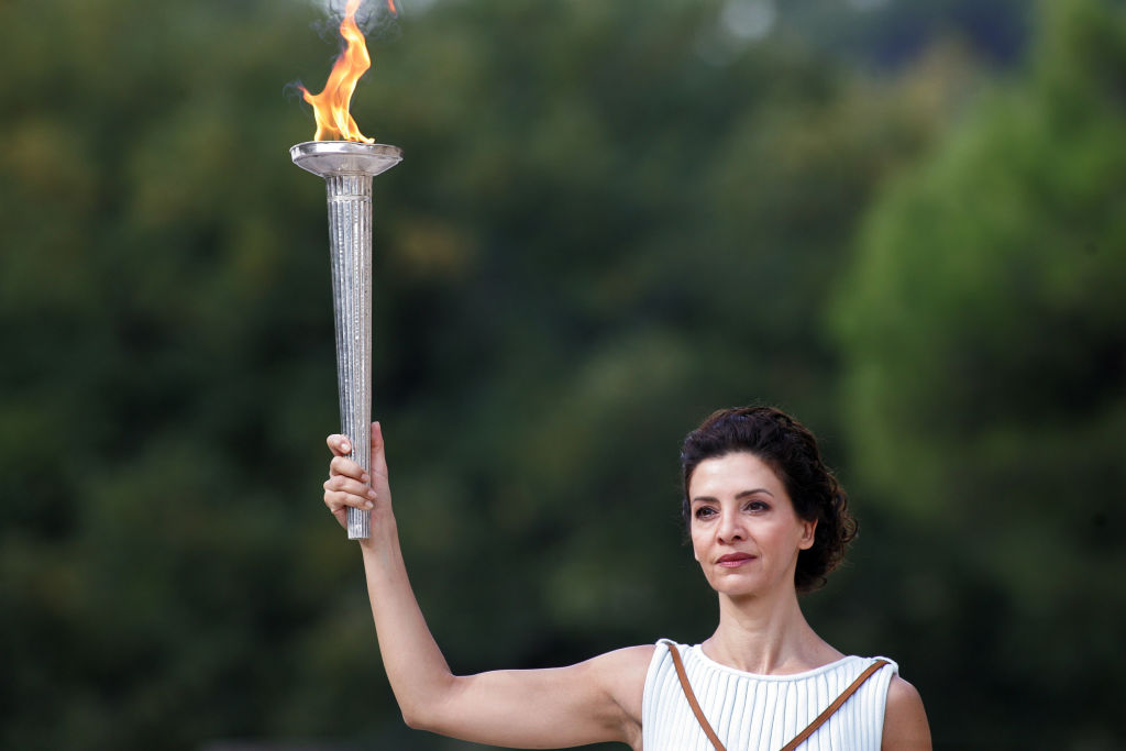 High priestess passes the Olympic flame at the Temple of Hera during a dressed rehearsal of the lighting ceremony of the Olympic flame in ancient Olympia