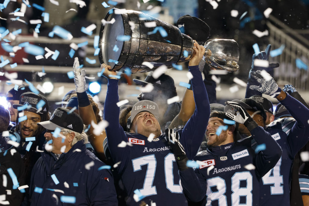 Lirim Hajrullahu of the Toronto Argonauts raises the Grey Cup after winning the 105th Grey Cup Championship Game against the Calgary Stampeders.