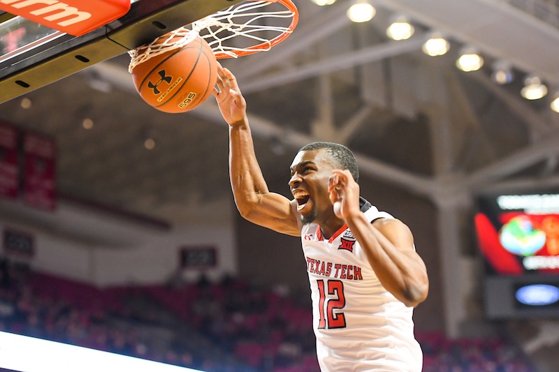 Keenan Evans dunking a basketball through a hoop. Keenan Evans dunking a basketball through a hoop.