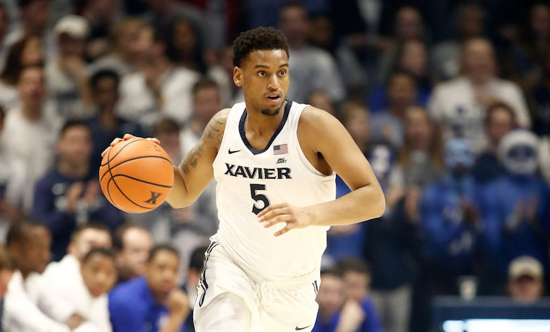 Trevon Bluiett dribbling a basketball on the court. Trevon Bluiett dribbling a basketball on the court.