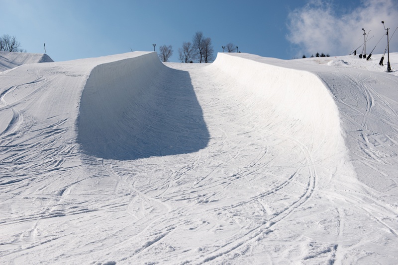 An Olympic-sized empty half pipe. An Olympic-sized empty half pipe.
