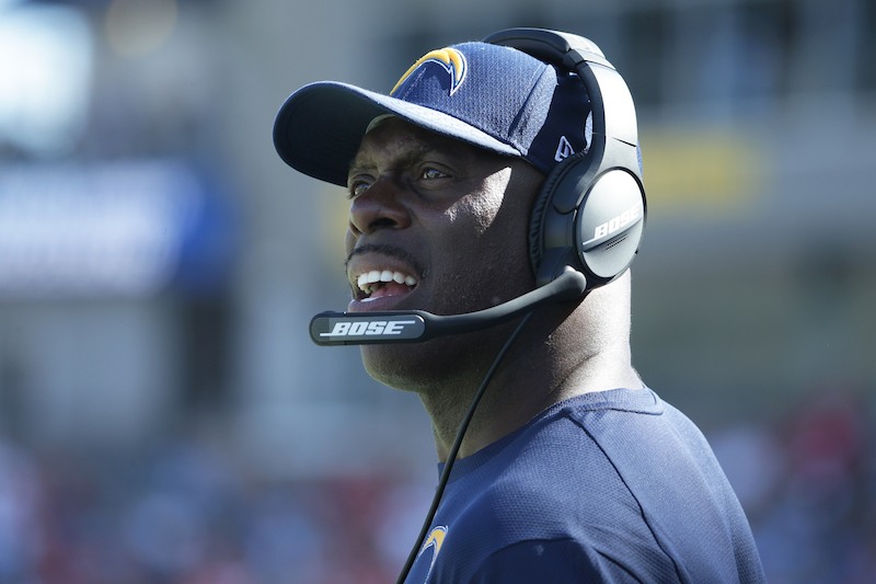 Anthony Lynn looking upward while wearing a black headset. 