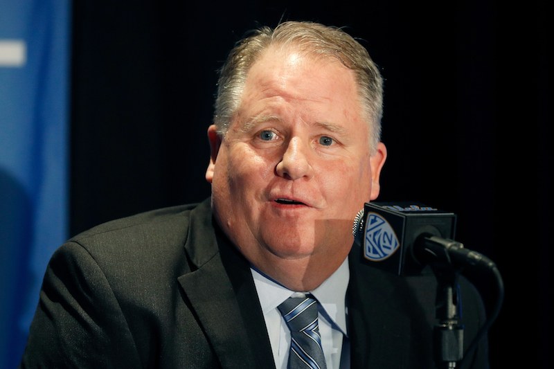 Chip Kelly speaking to the press during a conference. 