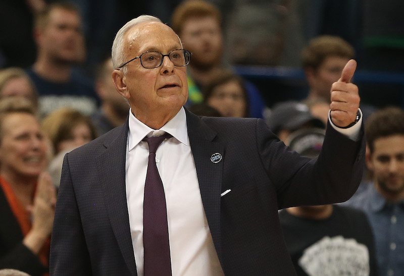 Larry Brown gesturing a "thumbs up" during a basketball game. 