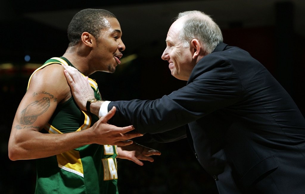 Lamar Butler of the George Mason Patriots celebrates with Coach Jim Larranaga.