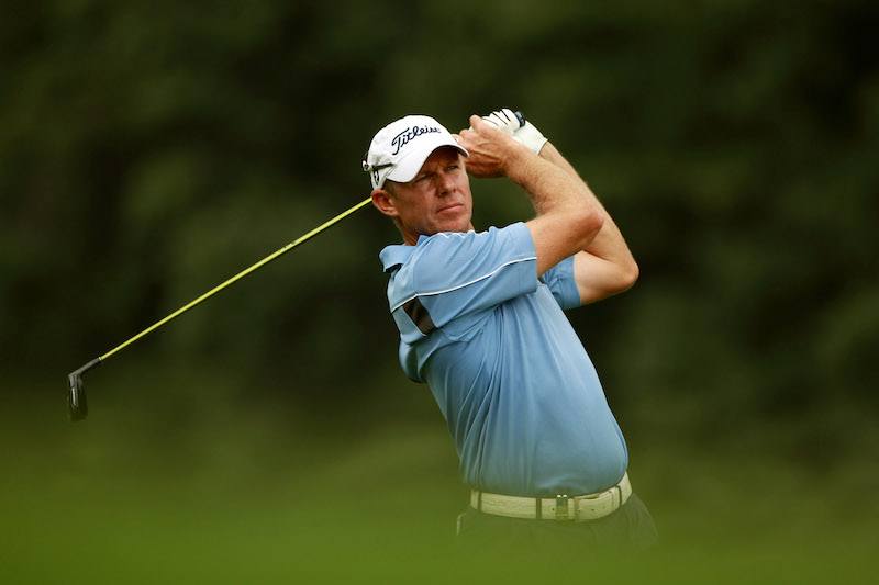 James Kingston swinging his club on the golf course. James Kingston swinging his club on the golf course.