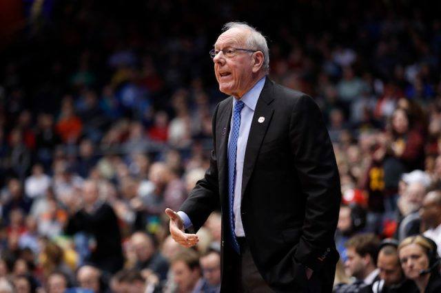 Jim Boeheim standing in a basketball court during a game. Jim Boeheim standing in a basketball court during a game.