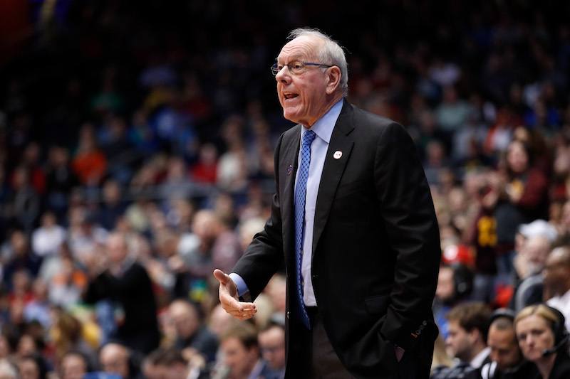 Jim Boeheim standing in a basketball court during a game. 