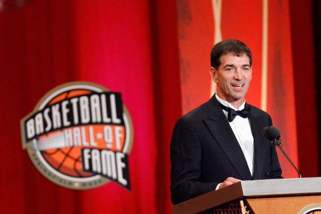 John Stockton speaking at a podium. John Stockton speaking at a podium.