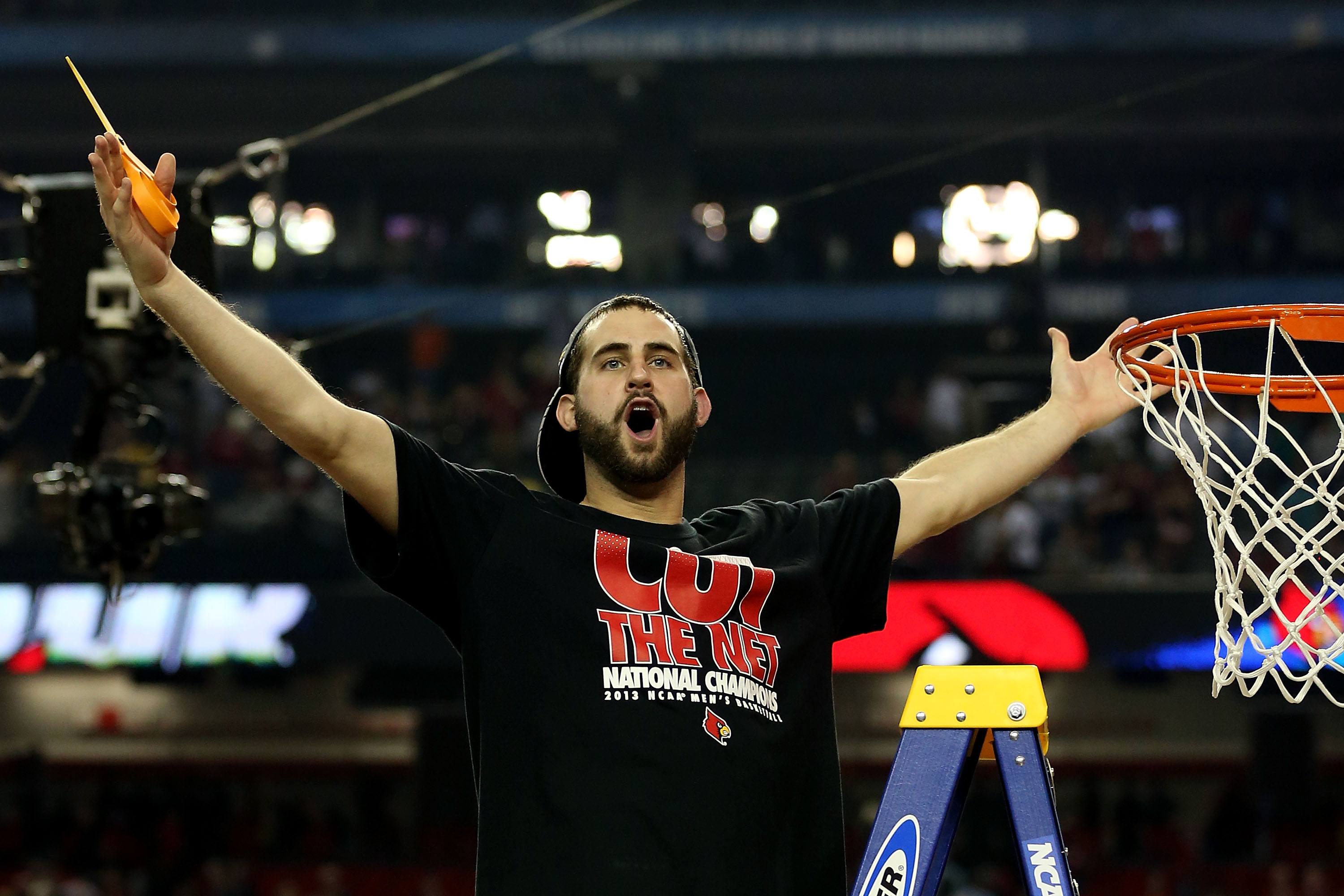 Luke Hancock #11 of the Louisville Cardinals celebrates as he cuts down the net