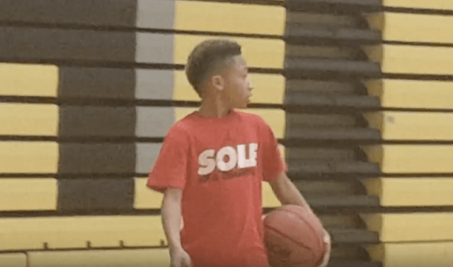 Jordan Lowery holding a basketball inside a gym. Jordan Lowery holding a basketball inside a gym.