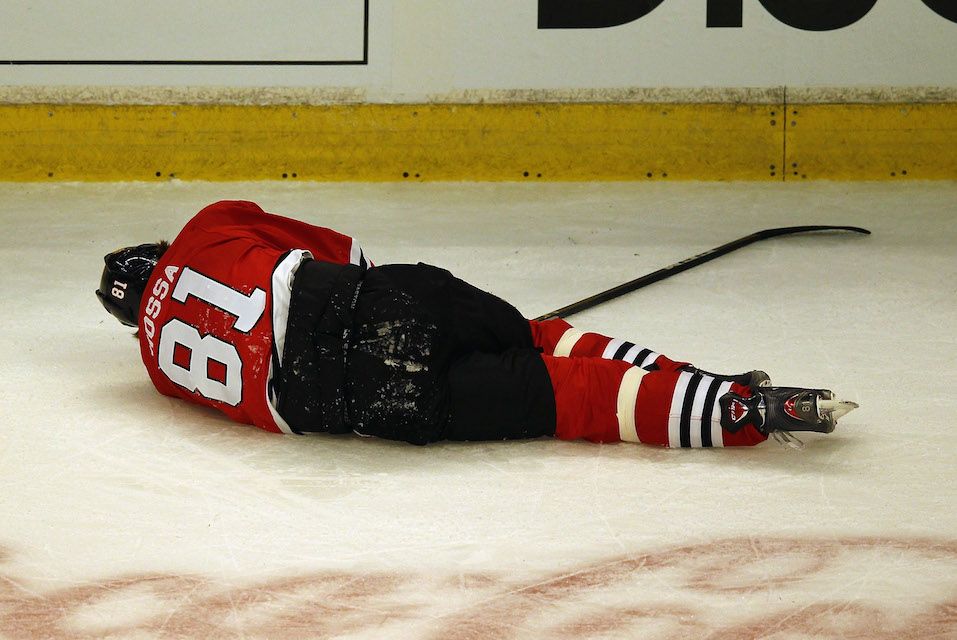 Marian Hossa #81 of the Chicago Blackhawks lays on the ice following a collison with Raffi Torres of the Phoenix Coyotes in Game Three