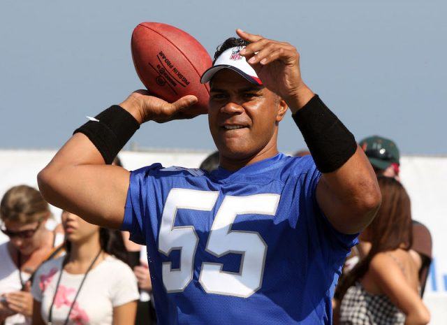 Junior Seau throwing a football. Junior Seau throwing a football.